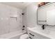 Modern bathroom featuring marble tile, a new vanity, and a tub with black fixtures at 3120 N 67Th Ln # 96, Phoenix, AZ 85033