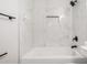 Elegant bathroom with marble tile, a bathtub, and sleek matte black fixtures at 3120 N 67Th Ln # 96, Phoenix, AZ 85033
