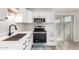 Modern kitchen with stainless steel appliances, white cabinets, and granite countertops at 3120 N 67Th Ln # 96, Phoenix, AZ 85033