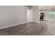 Bright living room features modern gray floors, white trim, and plenty of natural light at 3120 N 67Th Ln # 96, Phoenix, AZ 85033