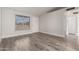 Inviting living room with a large window, new gray floors and lots of natural light at 3120 N 67Th Ln # 96, Phoenix, AZ 85033