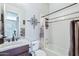 A charming bathroom featuring decorative wall art, and a shower-tub with modern shower curtain at 31626 N 129Th Dr, Peoria, AZ 85383