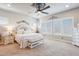 Spacious bedroom with a decorative ceiling fan and a plush bed and carpeted flooring at 31626 N 129Th Dr, Peoria, AZ 85383