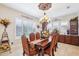 Formal dining room features a decorative ceiling, large windows, and an elegant chandelier at 31626 N 129Th Dr, Peoria, AZ 85383