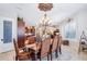 Elegant dining room is open to the kitchen, with a dark wood table and seating for eight at 31626 N 129Th Dr, Peoria, AZ 85383