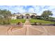 Stately home featuring an arched front porch, manicured lawn, and symmetrical landscaping at 31626 N 129Th Dr, Peoria, AZ 85383