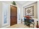 Elegant foyer with a dark wood door, tile flooring, and decorative accents at 31626 N 129Th Dr, Peoria, AZ 85383