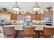 A large kitchen island offers seating, granite countertops, and pendant lighting at 31626 N 129Th Dr, Peoria, AZ 85383