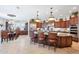 Open kitchen flows into the dining area, boasting a center island and stainless steel appliances at 31626 N 129Th Dr, Peoria, AZ 85383