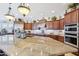 Spacious kitchen featuring stainless appliances, granite countertops, and ample cabinet space at 31626 N 129Th Dr, Peoria, AZ 85383