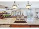 The kitchen island features a sink and offers seating, opening to the living area at 31626 N 129Th Dr, Peoria, AZ 85383
