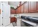 Laundry room with cabinets, a sink, countertop space and modern appliances at 31626 N 129Th Dr, Peoria, AZ 85383