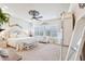 This bright and airy main bedroom boasts a decorative ceiling fan, plush carpeting and plantation shutters at 31626 N 129Th Dr, Peoria, AZ 85383