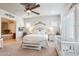 This bright, neutral main bedroom has an elegant ceiling fan, and connects to the main bath at 31626 N 129Th Dr, Peoria, AZ 85383