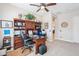 This home office features built in shelves, a computer desk, and lots of natural light at 31626 N 129Th Dr, Peoria, AZ 85383