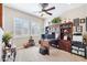 A bright office featuring built-in shelves, a ceiling fan, and windows with elegant plantation shutters at 31626 N 129Th Dr, Peoria, AZ 85383