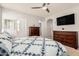 Spacious bedroom featuring neutral walls, carpeted floors, and dual dressers in addition to an archway to another room at 32405 N 23Rd Ave, Phoenix, AZ 85085