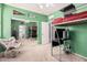 Shared bedroom with bright green walls, a bunk bed, a mirror, and a sitting chair at 32405 N 23Rd Ave, Phoenix, AZ 85085