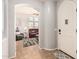Light-filled entryway transitions into the living area featuring tile floors and neutral walls at 32405 N 23Rd Ave, Phoenix, AZ 85085