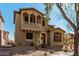 Charming two-story home featuring a quaint balcony and a well-manicured desert landscape at 32405 N 23Rd Ave, Phoenix, AZ 85085