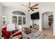 Open living room boasts a large window, ceiling fan, and ample seating space at 32405 N 23Rd Ave, Phoenix, AZ 85085