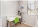 Functional home office space with a modern desk, a bright green chair, a window, and neutral wall paint at 32405 N 23Rd Ave, Phoenix, AZ 85085