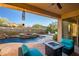 Inviting covered patio beside the backyard pool and spa with lounge seating and desert views at 3318 W Ravina Ln, Anthem, AZ 85086