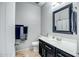 Clean bathroom featuring a single sink vanity, a toilet, and a framed mirror at 3318 W Ravina Ln, Anthem, AZ 85086