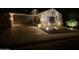 Charming single story home with desert landscaping illuminated with outdoor lighting at 3318 W Ravina Ln, Anthem, AZ 85086