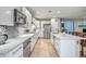 Spacious kitchen with a breakfast bar, stainless steel appliances, and tile backsplash at 3318 W Ravina Ln, Anthem, AZ 85086