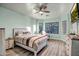 Relaxing main bedroom with natural light, a ceiling fan, and laminate wood flooring at 3318 W Ravina Ln, Anthem, AZ 85086