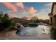 Resort style pool and spa with rock waterfall feature and mountain views at 3318 W Ravina Ln, Anthem, AZ 85086
