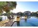 Backyard patio overlooks lake and infinity pool with views of waterfront homes and landscaping at 3370 S Ivy Way, Chandler, AZ 85248
