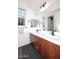 Bathroom with double vanity, wood cabinets, sleek black fixtures, and a large mirror at 3370 S Ivy Way, Chandler, AZ 85248