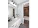 Bathroom featuring light blue walls, a white vanity, and a contrasting tiled shower area at 3370 S Ivy Way, Chandler, AZ 85248