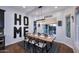 Bright dining room with a rustic wooden table, modern chairs, and ample natural light at 3370 S Ivy Way, Chandler, AZ 85248