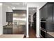 Modern kitchen featuring stainless steel refrigerator, gray cabinets, and view into next room at 3370 S Ivy Way, Chandler, AZ 85248