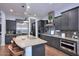 Well-equipped kitchen with a center island, stainless steel appliances, and dark cabinetry, perfect for culinary enthusiasts at 3370 S Ivy Way, Chandler, AZ 85248