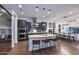 Modern kitchen with stainless steel appliances, a center island, and a connected dining area at 3370 S Ivy Way, Chandler, AZ 85248