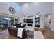 Spacious living room with built-in shelving, large windows, and a comfortable leather sectional at 3370 S Ivy Way, Chandler, AZ 85248