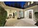 Charming front patio with pavers, fireplace, seating area, and a decorative wooden front door at 3370 S Ivy Way, Chandler, AZ 85248