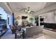 Covered patio with wicker seating, ceiling fan, outdoor TV, and sliding glass doors at 3370 S Ivy Way, Chandler, AZ 85248
