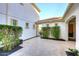 Private courtyard with pavers, a black iron gate, lush greenery, and access to the main house at 3370 S Ivy Way, Chandler, AZ 85248