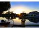Picturesque sunset view over the pond with water features and nearby homes at 3370 S Ivy Way, Chandler, AZ 85248