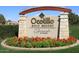 Welcome to Ocotillo Golf Resort sign with stone accents and colorful flowers at 3370 S Ivy Way, Chandler, AZ 85248
