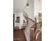 Elegant curved staircase with carpeted steps, wooden railing, and black iron balusters at 3370 S Ivy Way, Chandler, AZ 85248