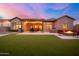 Backyard with fire pit and patio with seating under a pergola at dusk at 346 W Alamosa Dr, Chandler, AZ 85248