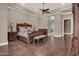 Primary bedroom featuring a tray ceiling, dark wood floors, and warm paint tones at 346 W Alamosa Dr, Chandler, AZ 85248