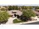 Aerial view of a stunning home with lush landscaping, a three-car garage, and a nearby lake at 3654 E San Pedro Pl, Chandler, AZ 85249