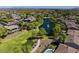 Aerial view of the community with a pond, fountain, green space, and mature trees at 3654 E San Pedro Pl, Chandler, AZ 85249